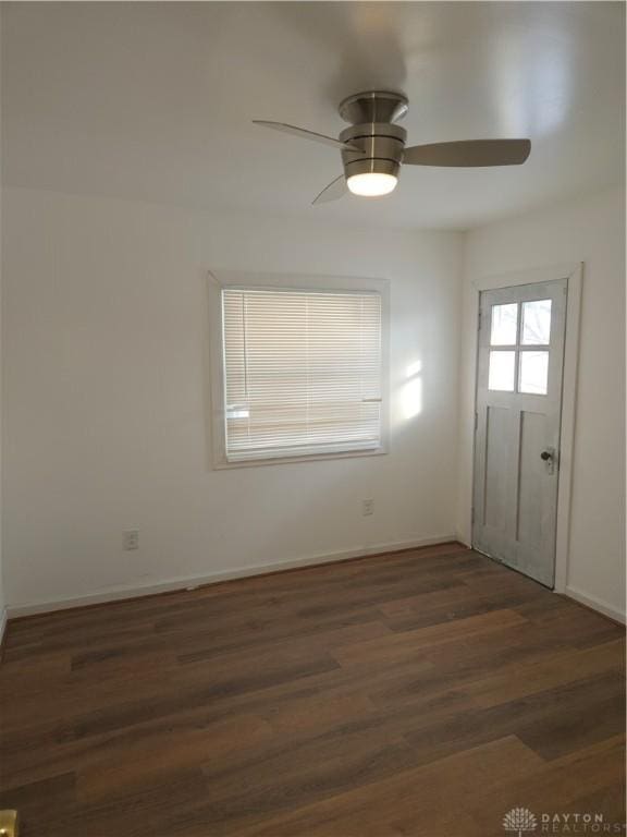 unfurnished room featuring ceiling fan and dark hardwood / wood-style flooring