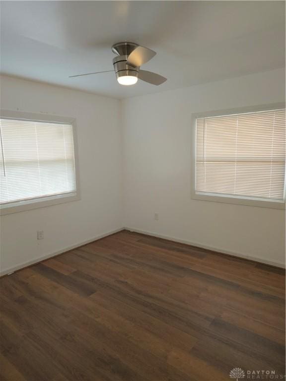 spare room featuring dark hardwood / wood-style floors and ceiling fan