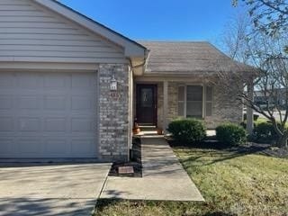 view of front of property with a garage and a front yard