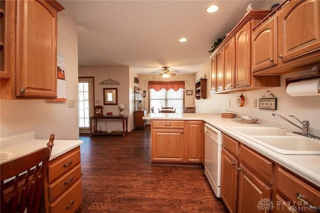 kitchen featuring dishwasher, sink, ceiling fan, dark hardwood / wood-style flooring, and kitchen peninsula