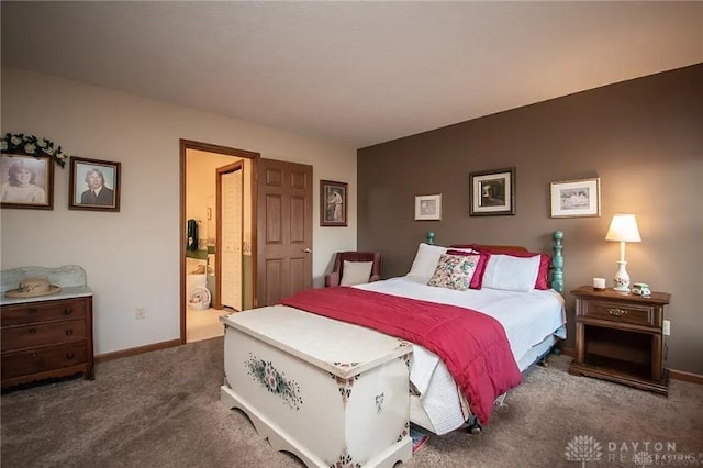 bedroom featuring dark carpet and ensuite bath