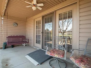 property entrance with ceiling fan and a balcony