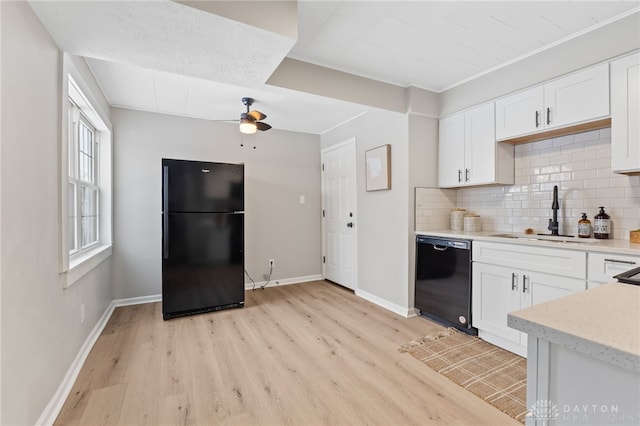 kitchen with sink, decorative backsplash, black appliances, and white cabinets