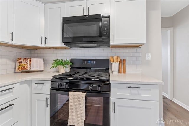 kitchen featuring black appliances and white cabinets