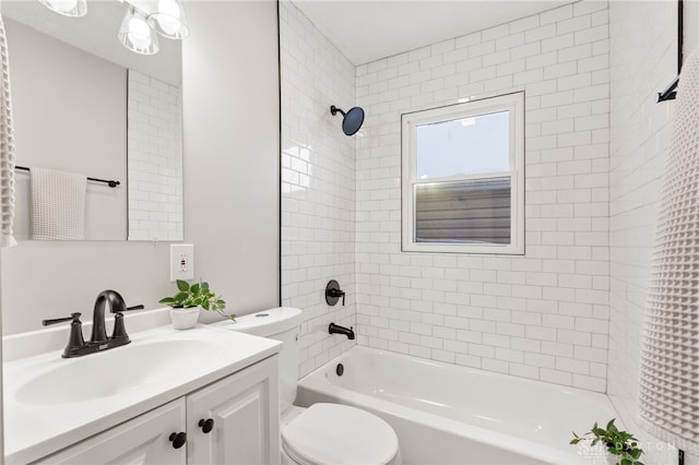 full bathroom with tiled shower / bath combo, vanity, and toilet