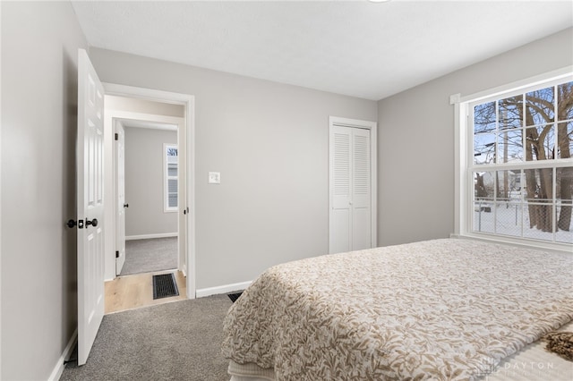 carpeted bedroom with a closet