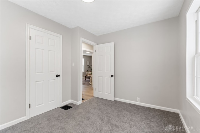 unfurnished bedroom featuring a closet and carpet