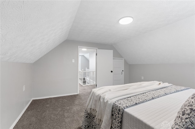 carpeted bedroom with vaulted ceiling and a textured ceiling