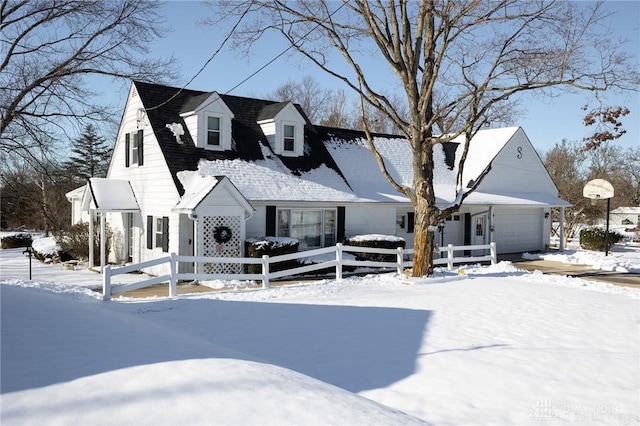 cape cod-style house featuring a garage