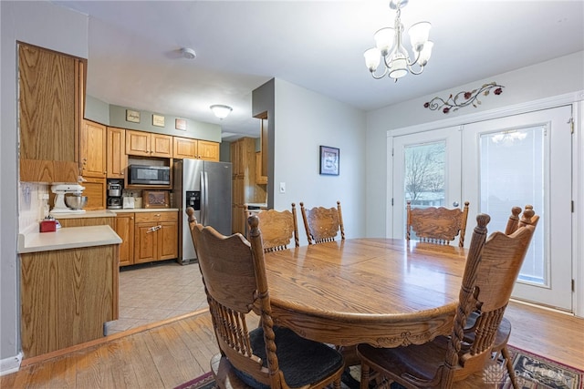 dining room with a notable chandelier and light hardwood / wood-style flooring