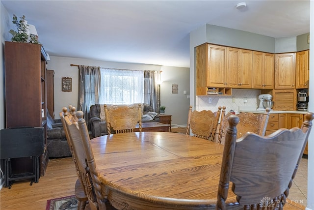 dining space with light wood-type flooring