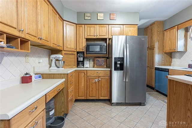 kitchen with backsplash, light tile patterned flooring, and stainless steel appliances