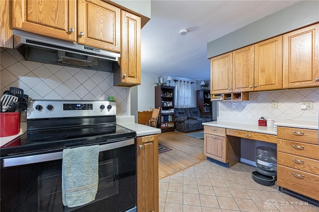 kitchen featuring tasteful backsplash, electric stove, and light tile patterned floors