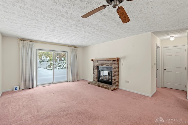 unfurnished living room with carpet, ceiling fan, and a brick fireplace