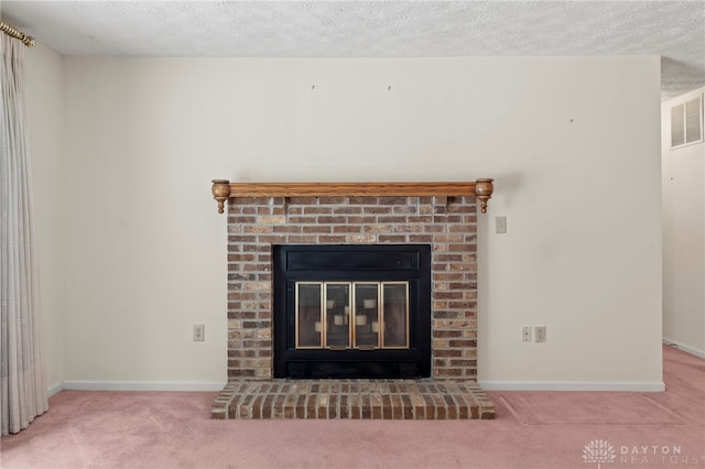 room details featuring carpet, a textured ceiling, and a brick fireplace