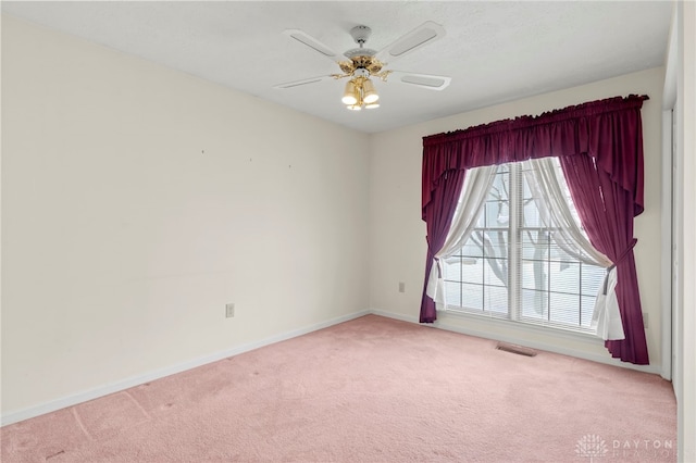 carpeted spare room with ceiling fan