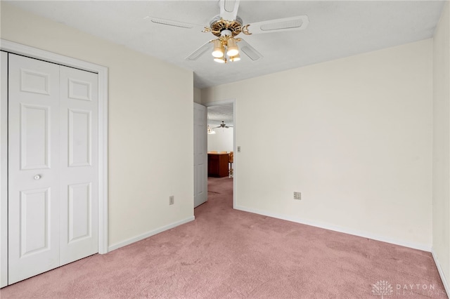 unfurnished bedroom with light carpet, a closet, and ceiling fan