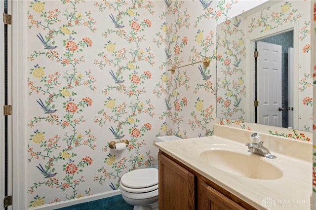 bathroom featuring vanity and toilet