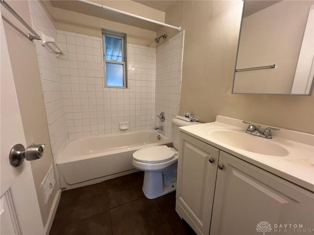 full bathroom with tile patterned floors, vanity, toilet, and tiled shower / bath combo