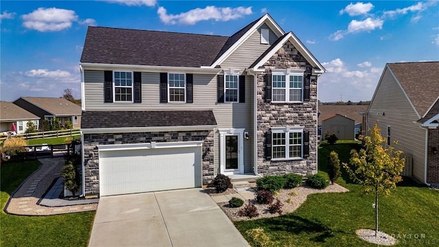 view of front of property featuring a garage and a front lawn