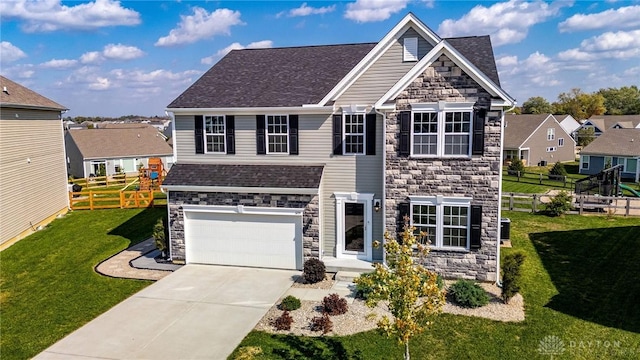 view of front of property with a front yard and a garage