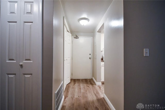 corridor with light hardwood / wood-style flooring