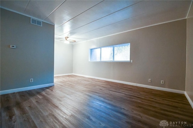 spare room featuring ceiling fan and dark wood-type flooring