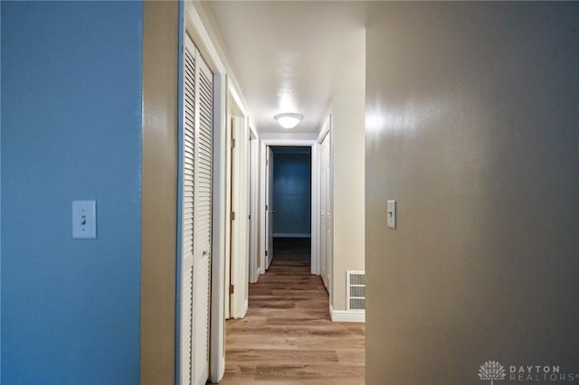 corridor with light wood-type flooring