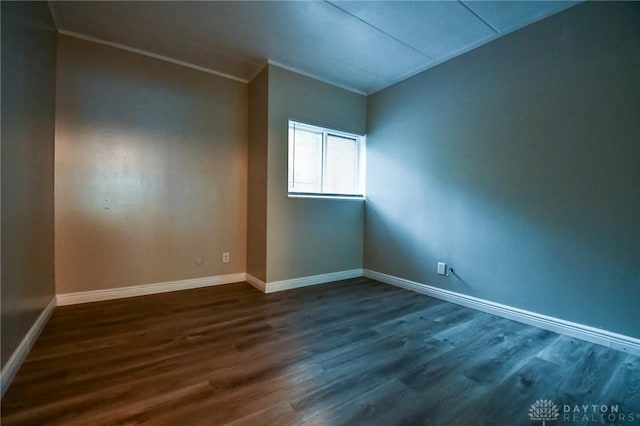 spare room with dark hardwood / wood-style floors