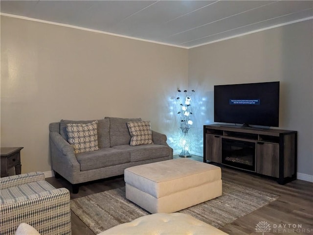 living room with dark hardwood / wood-style floors and crown molding