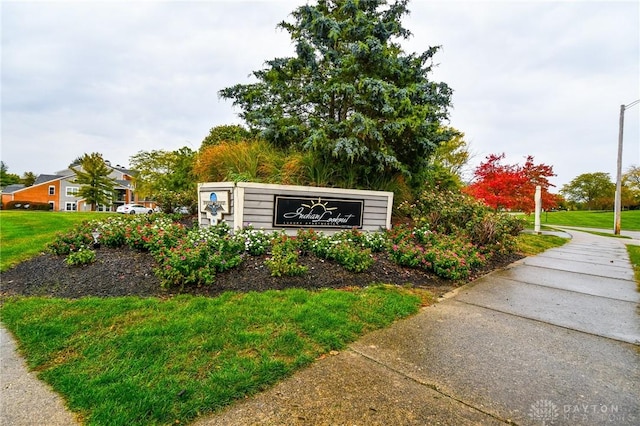 community / neighborhood sign with a lawn