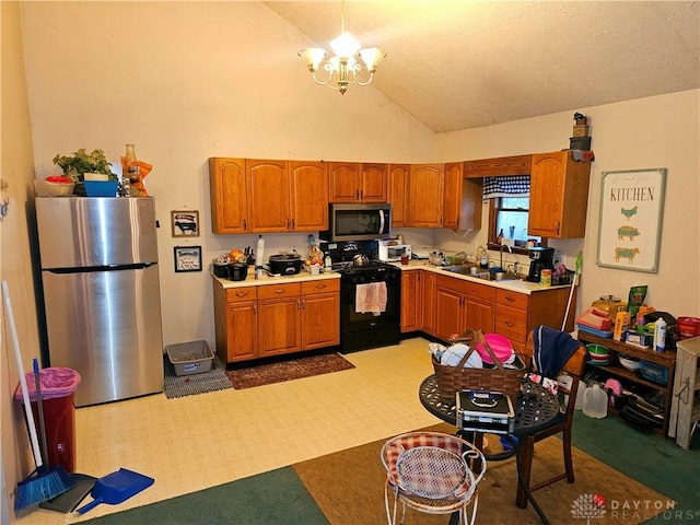 kitchen featuring appliances with stainless steel finishes, a textured ceiling, sink, high vaulted ceiling, and a chandelier