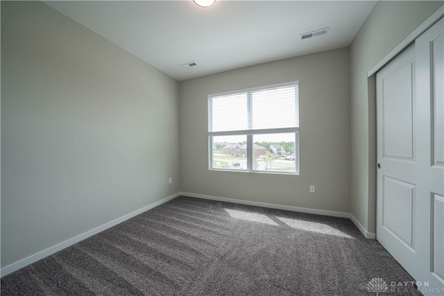 unfurnished bedroom featuring carpet flooring and a closet