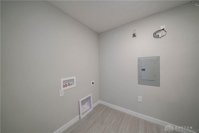 laundry room featuring electric panel, hookup for a washing machine, light hardwood / wood-style floors, and hookup for an electric dryer