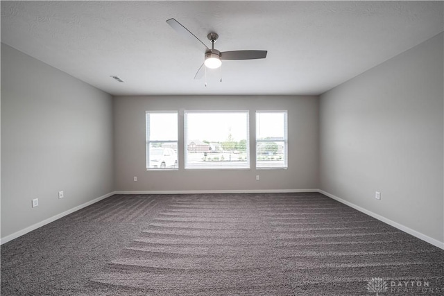 carpeted empty room featuring ceiling fan