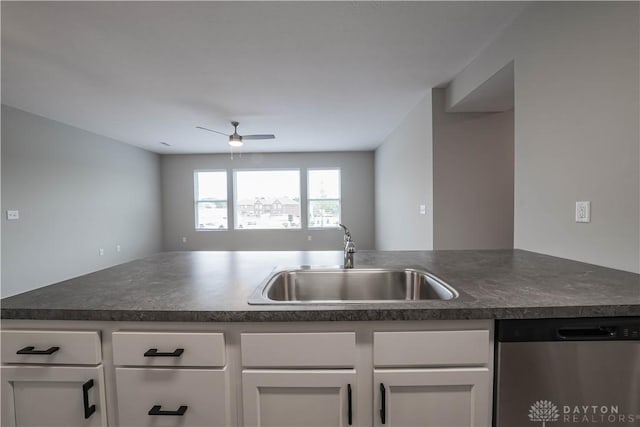 kitchen with stainless steel dishwasher, ceiling fan, white cabinetry, and sink