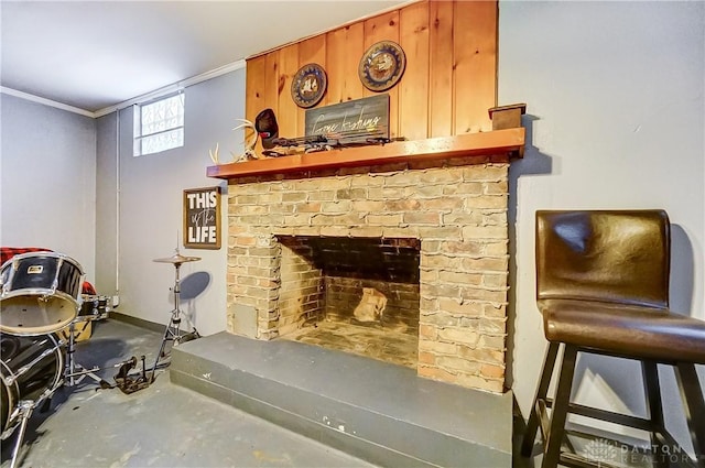 interior space featuring concrete flooring, crown molding, and a brick fireplace