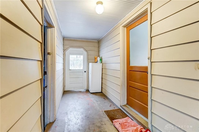 doorway with wood walls