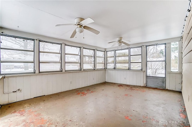 unfurnished sunroom with ceiling fan