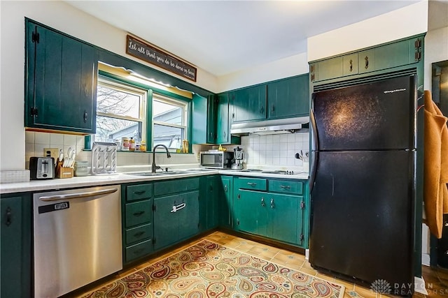 kitchen featuring light tile patterned flooring, appliances with stainless steel finishes, tasteful backsplash, and sink