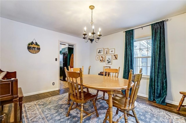 dining room with a notable chandelier and dark hardwood / wood-style floors