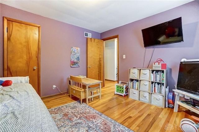 bedroom with hardwood / wood-style floors