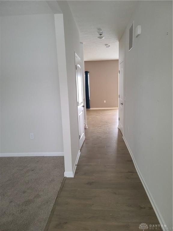 corridor with dark wood-type flooring