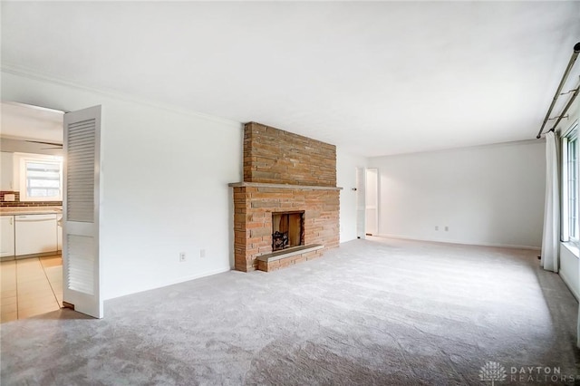 unfurnished living room with a fireplace, light carpet, and ornamental molding