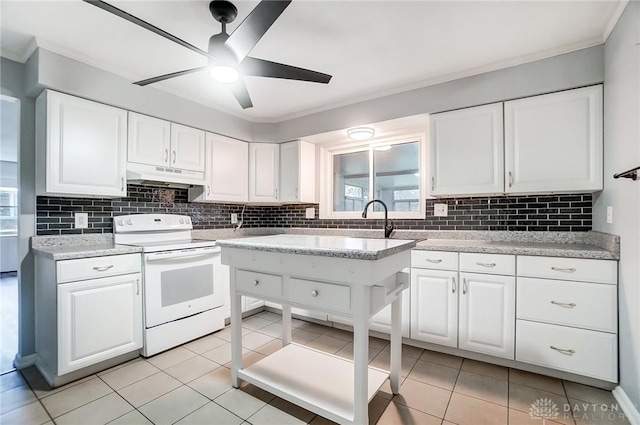 kitchen with ceiling fan, decorative backsplash, light tile patterned floors, white electric range oven, and white cabinetry