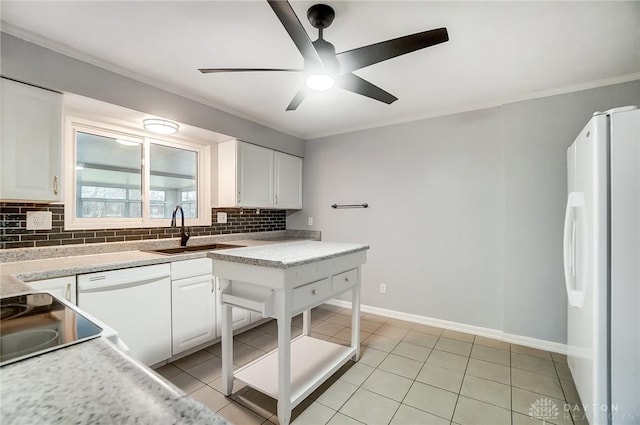 kitchen with white appliances, backsplash, white cabinets, sink, and light tile patterned flooring