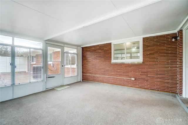 unfurnished sunroom with beam ceiling