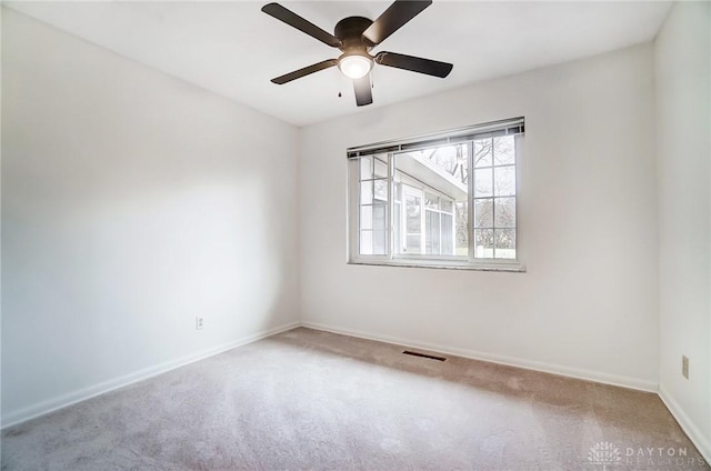 carpeted empty room featuring ceiling fan