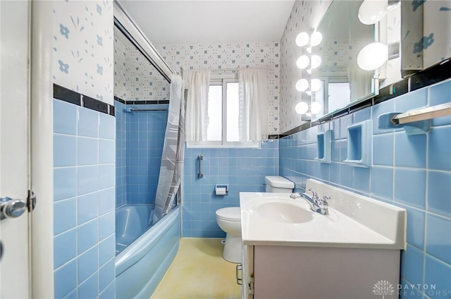 full bathroom featuring vanity, toilet, shower / bathtub combination with curtain, and tile walls