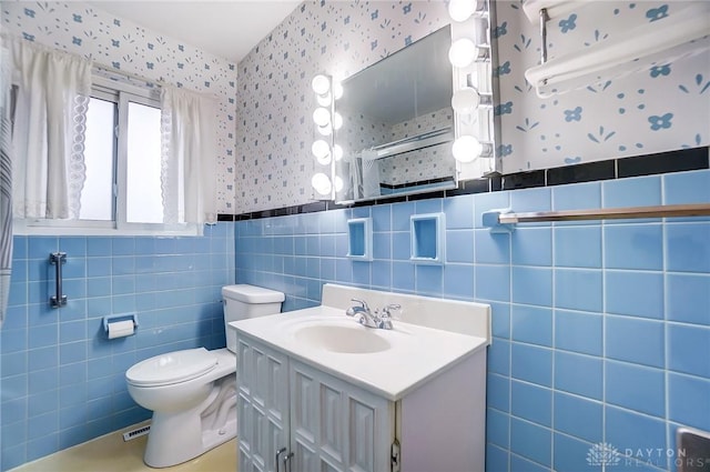 bathroom featuring toilet, vanity, tile walls, and a shower with shower curtain